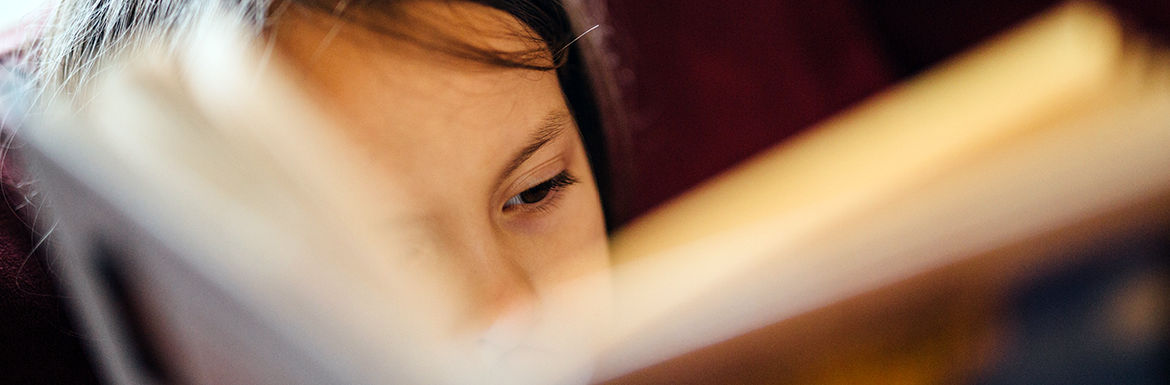 Dyslexia stock header Child reading book