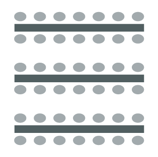 Long table with chairs on both sides. 