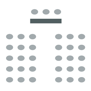 Two columns of chair with a table facing the columns