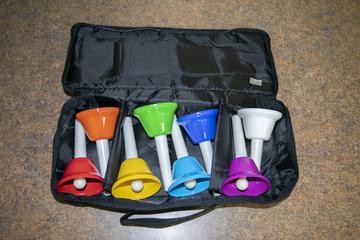 8 handbells of different colors in a black case