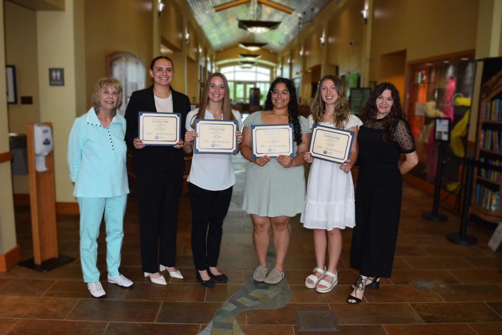 2025 Scholarship Winners proudly showing off their certificates. 