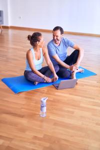 Yoga Couple Looking at Laptop