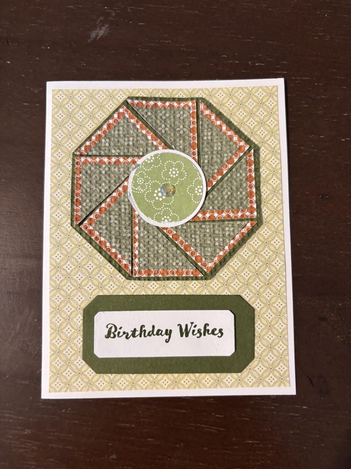 A handmade greeting card in brown, tan, and green. Happy Birthday is the memo on it.